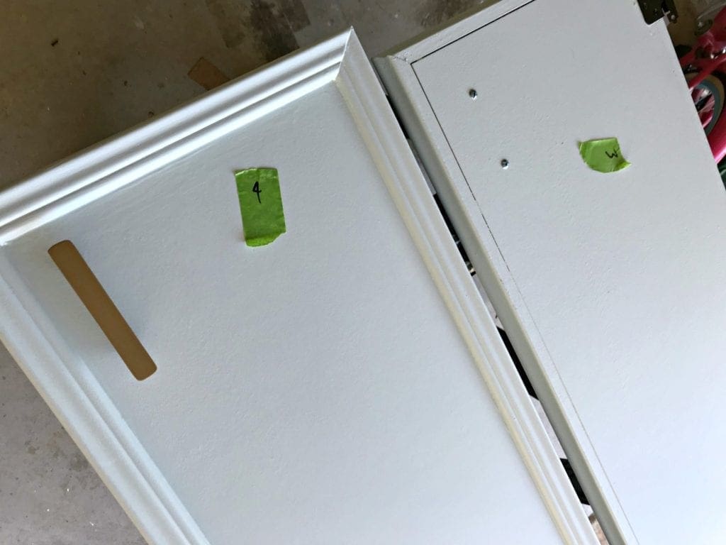 Before and after painted cabinet transformation. This easy DIY project, with or without sanding, can take old drap cabinets into a high impact statement. Ideas for your kitchen, bathroom or laundry room. 9 things to know when you are painting cabinets with with a sprayer or with brushes. #beforeandafter #DIY #kitchen #bathroom #laundryroom #colors #interiordesign #farmhouse