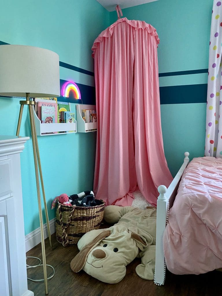 Rainbow reading nook in a tomboy bedroom.